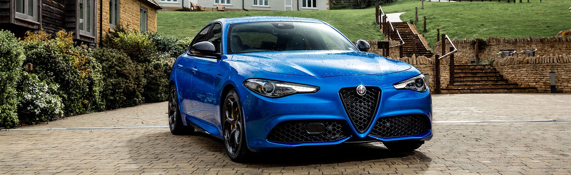 Blue Alfa Romeo Giulia in the coutryside from the front.