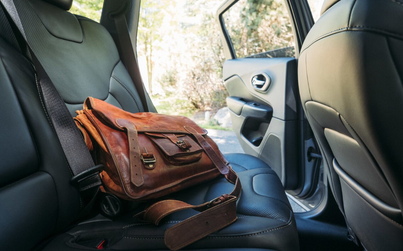 brown leather bag on the backseat of a 2023 Jeep Cherokee