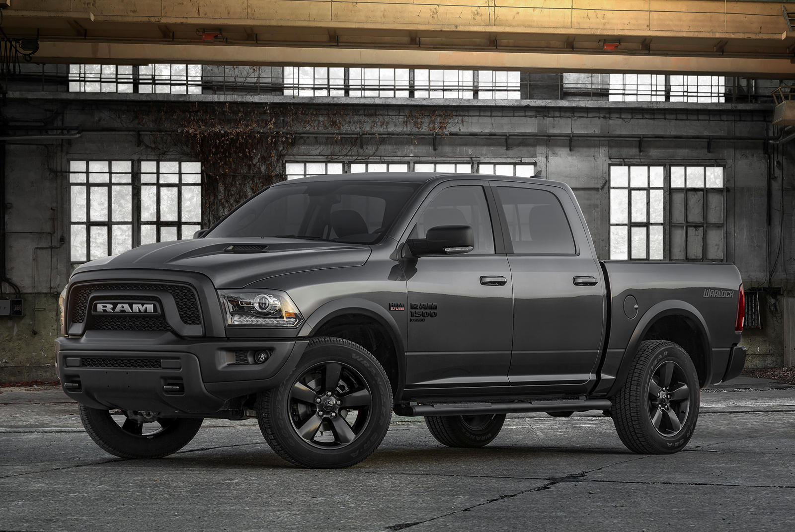 front side view of a 2023 RAM 1500 Classic Warlock in an old warehouse