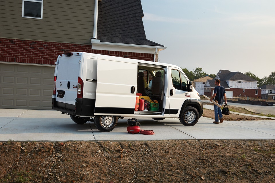 2020 Ram Promaster exterior gallery parked side house man holding plank