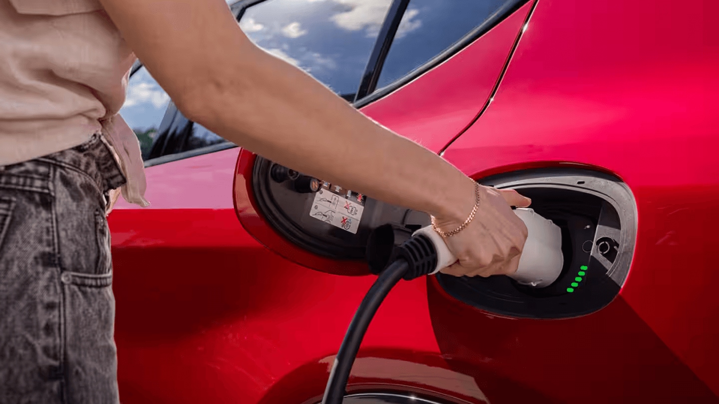 Learn about the 2025 Dodge Hornet An exterior shot of the Dodge Hornet's plug-in hybrid charging port