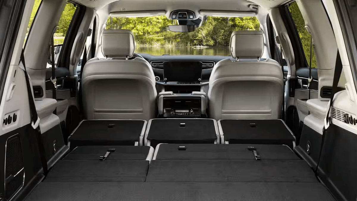 Learn about the interior design of the Jeep Grand Wagoneer Jeep Wagoneer interior with second and third row seats folded down to show maximum cargo space