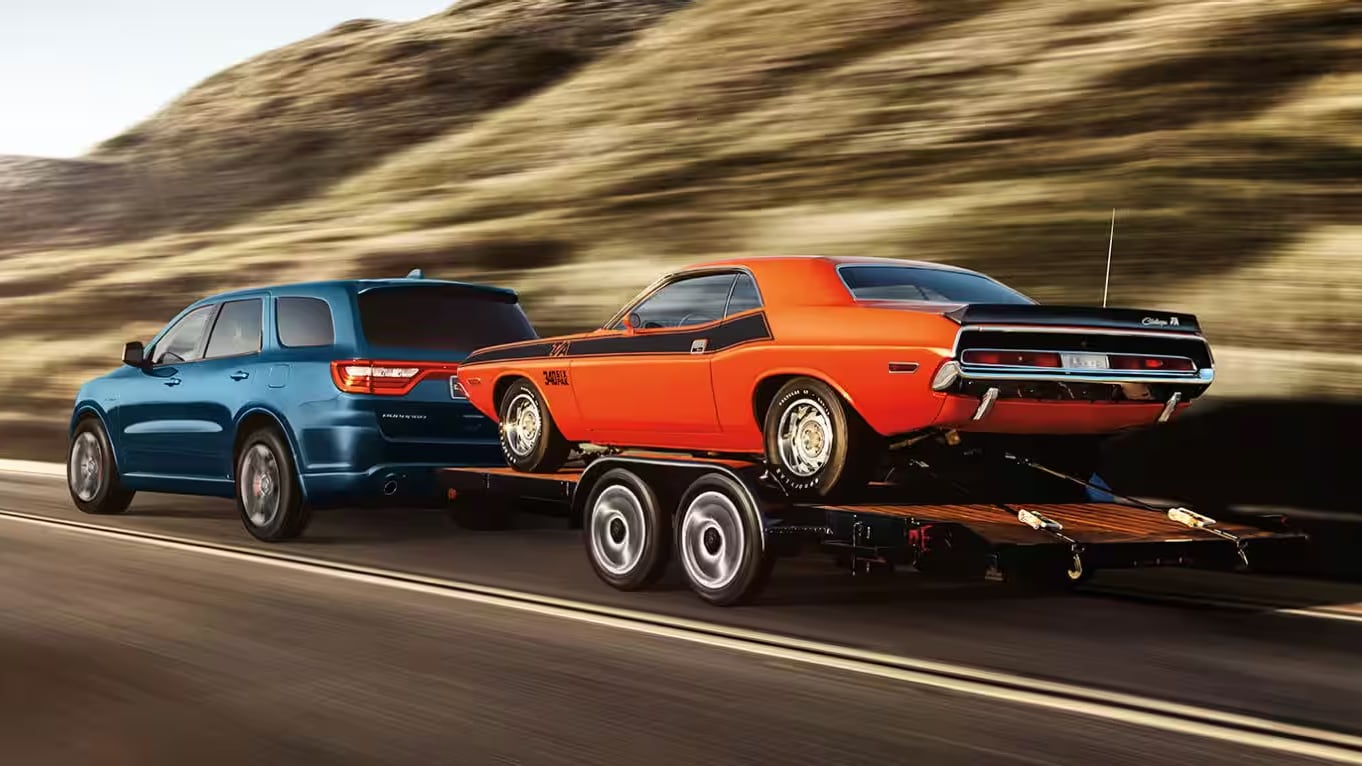 An image of a Dodge Durango Towing a Vintage Dodge Charger