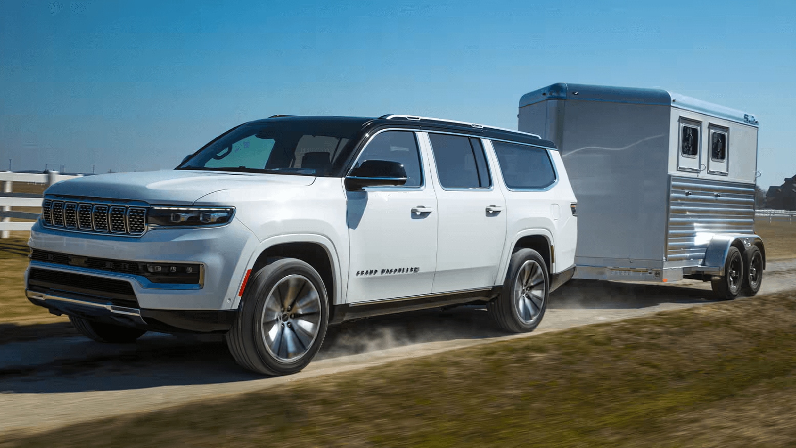 Learn about the performance features of the Jeep Wagoneer Action shot of a Jeep Grand Wagoneer towing an RV trailer