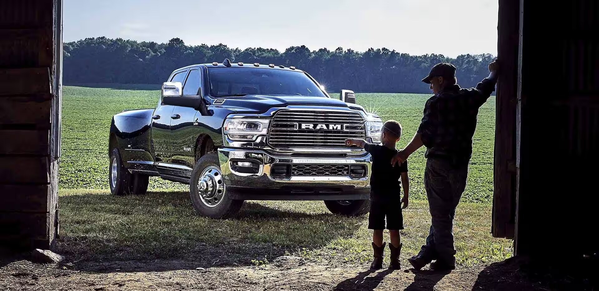 A father and son look at a Ram 3500