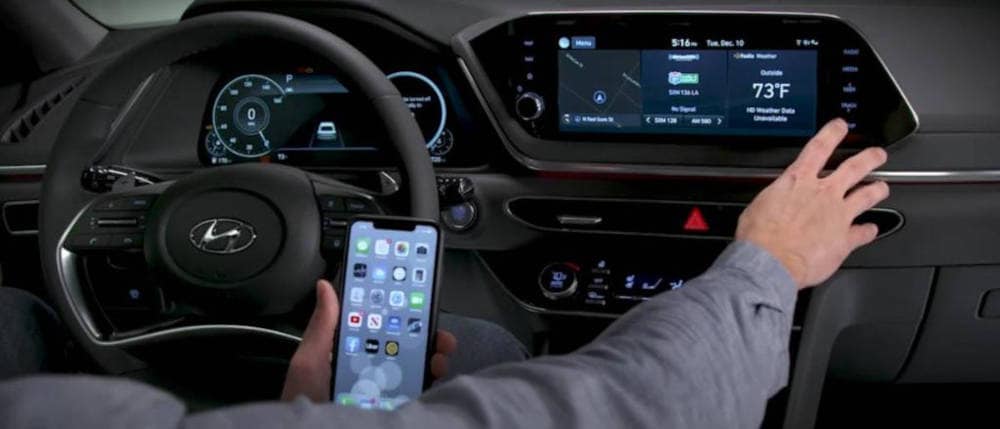 man using Apple carplay in a Hyundai