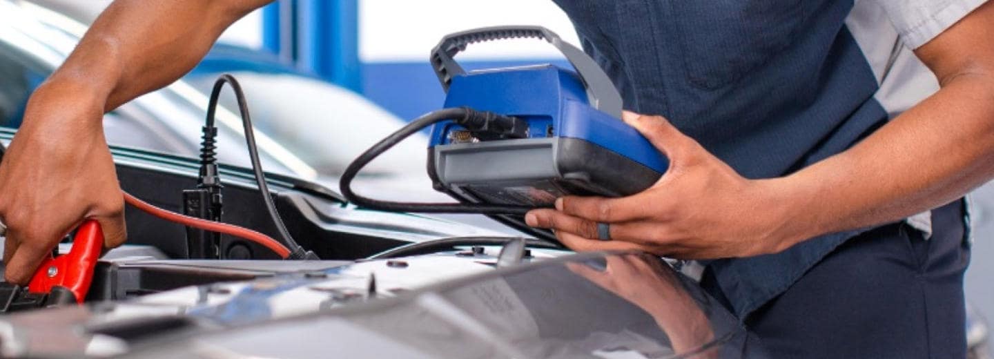 Mechanic doing battery service on a Hyundai