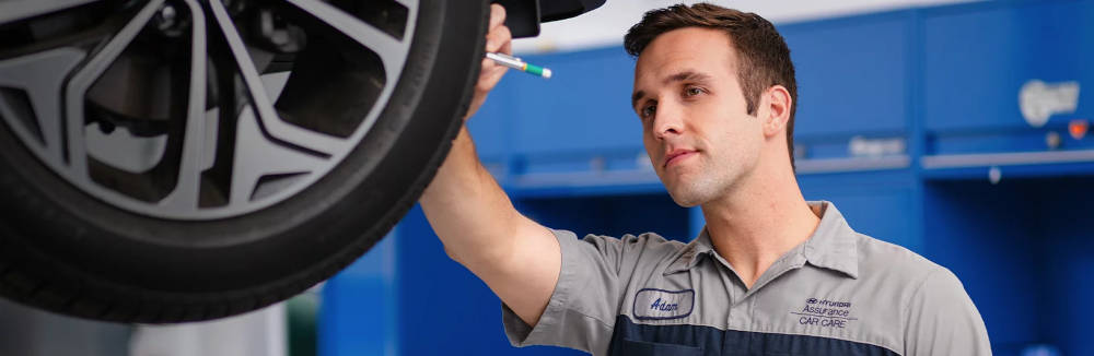 Hyundai mechanic checking a tire