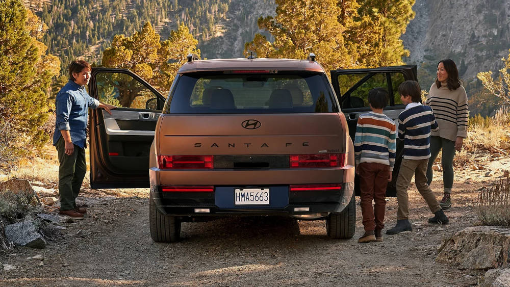 Hyundai Santa Fe parked with a family getting in