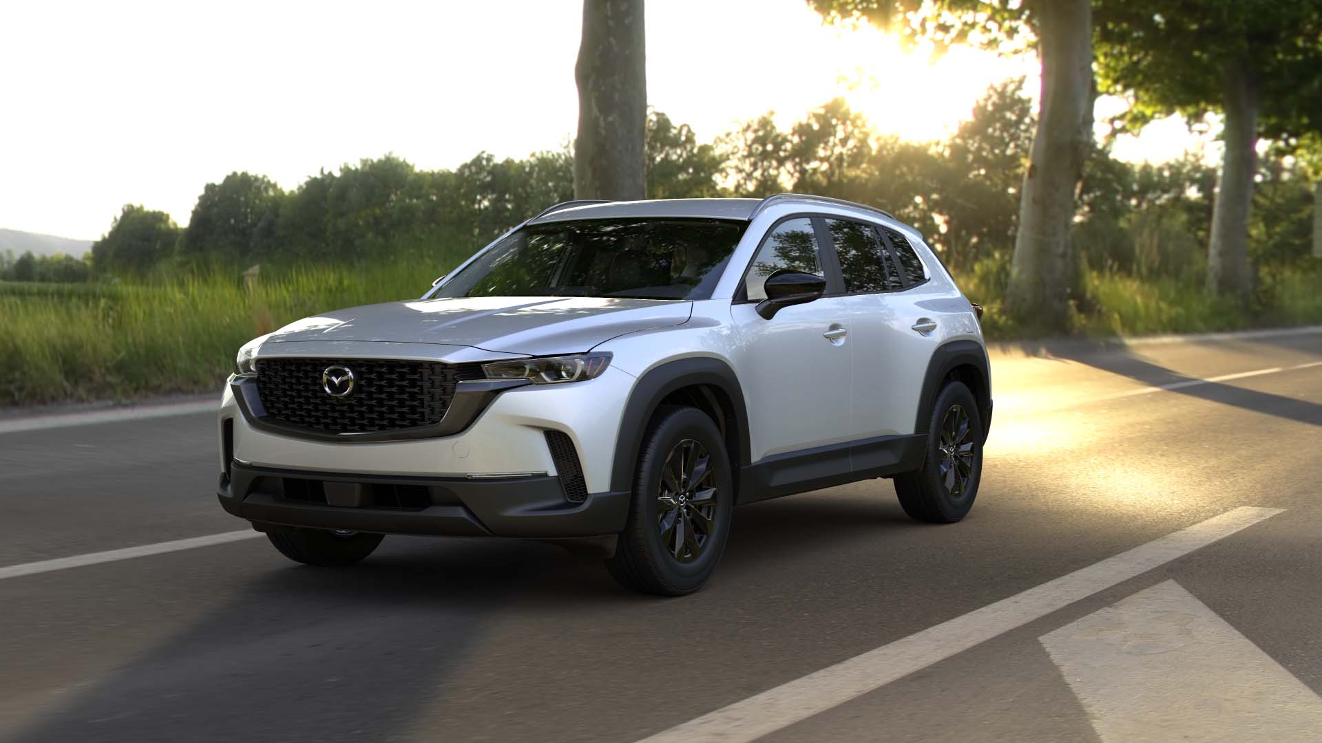 2024 Mazda CX-50 driving down the road