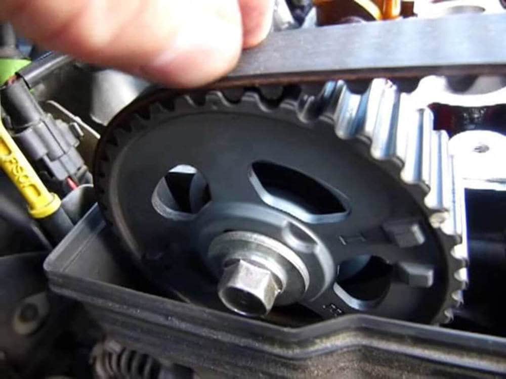 mechanic changing timing belt of Mazda