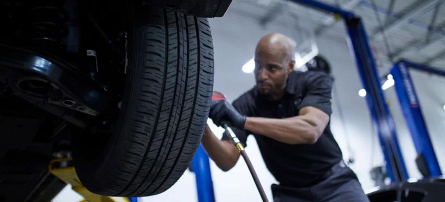 Mazda mechanic doing a wheel alignment