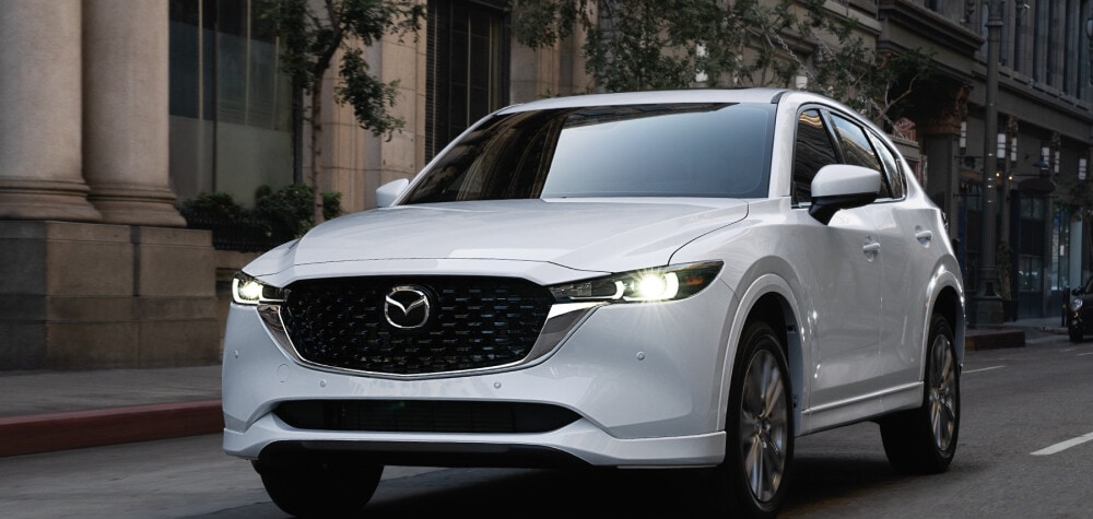 2023 Mazda CX-5 driving through a city neighborhood