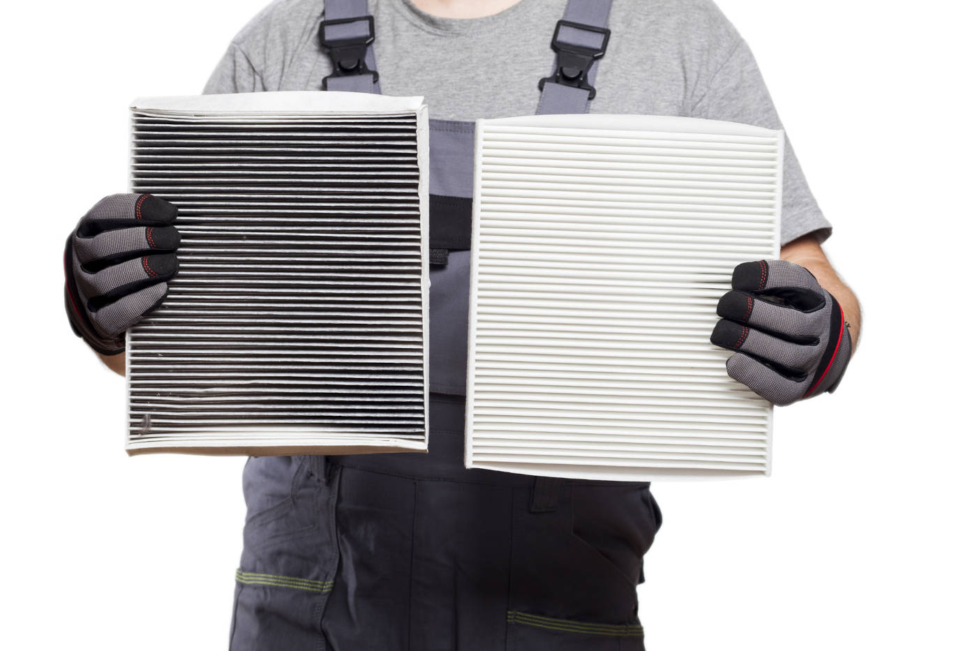 Mechanic holding a dirty and clean cabin filter