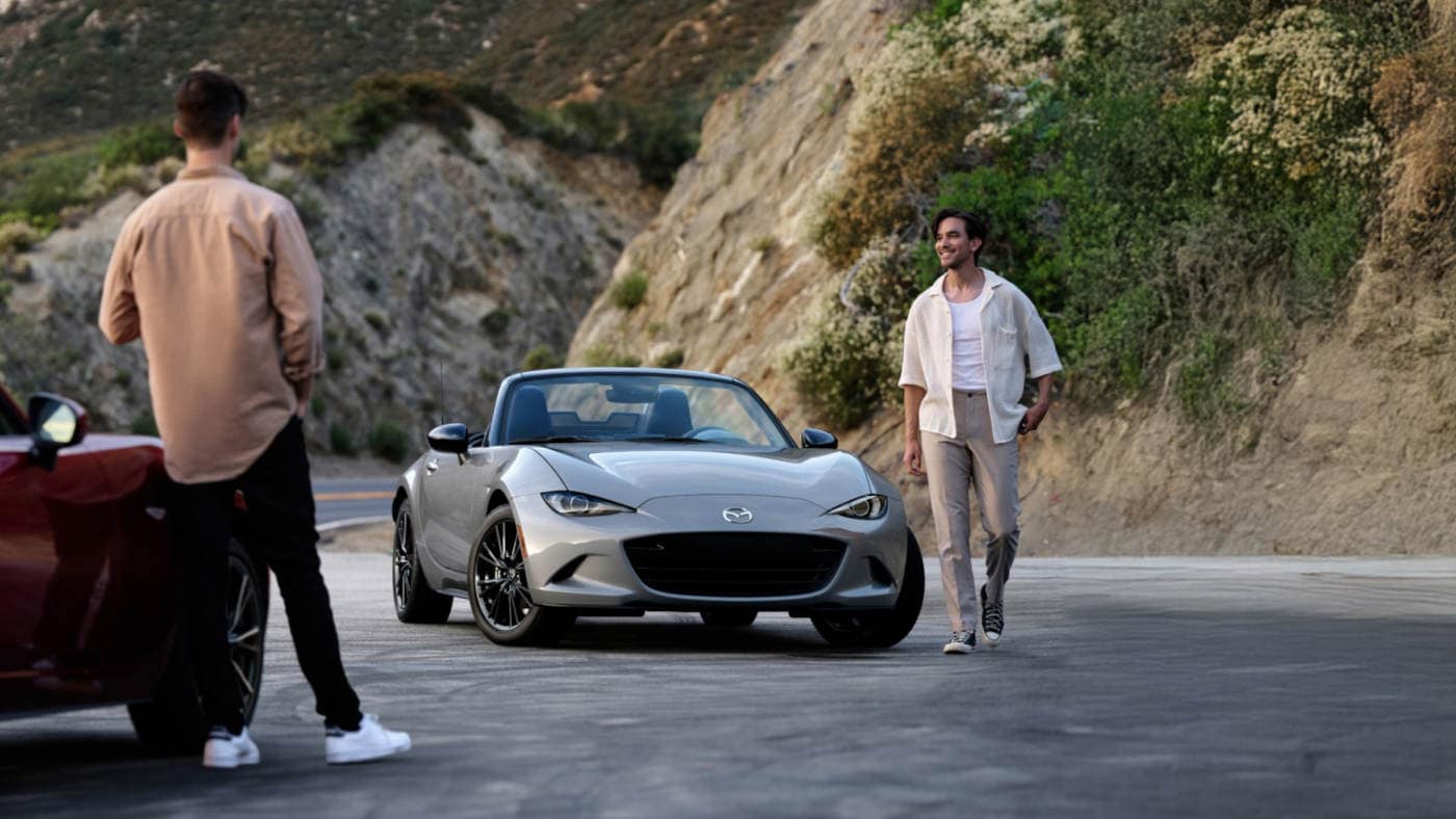2025 Mazda MX-5 Miata parked with a man walking away from it