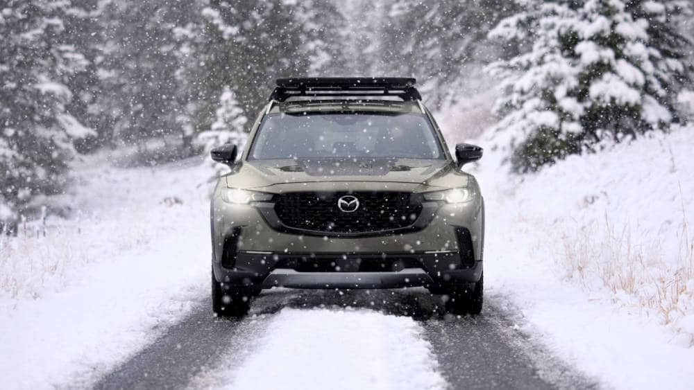 2025 Mazda CX-50 driving through the snow