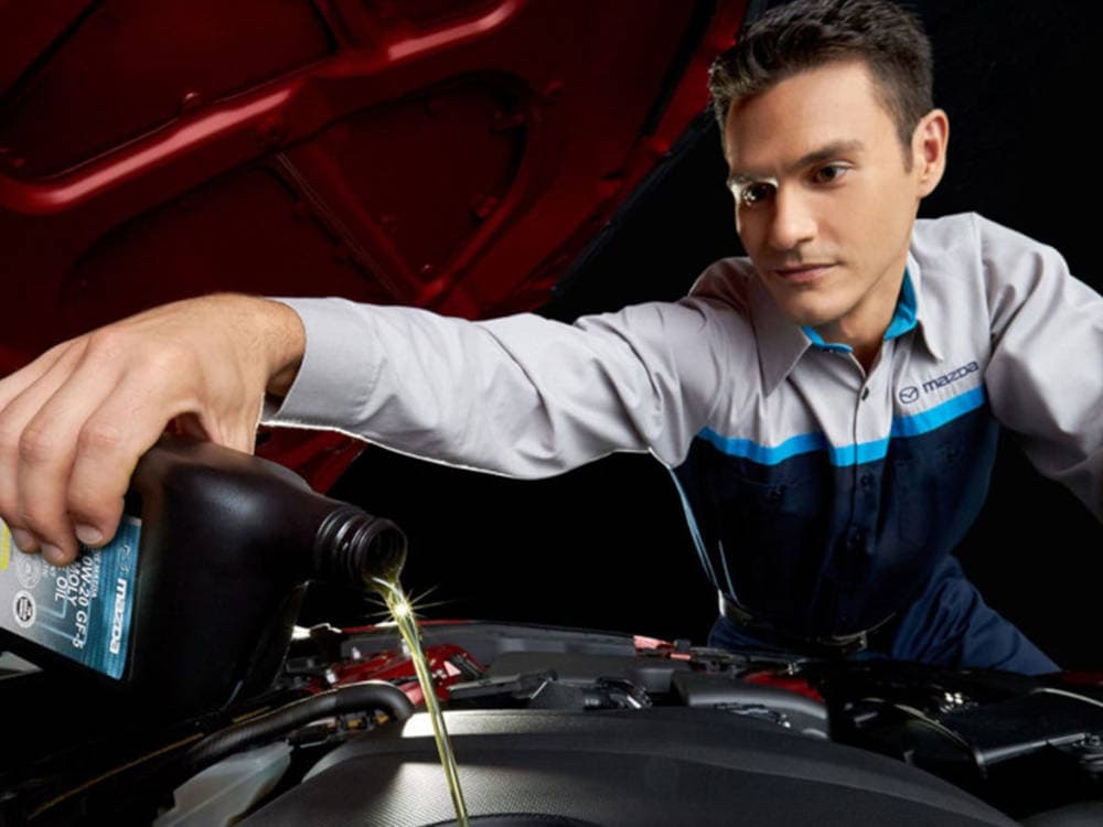 Mazda Mechanic changing the oil 
