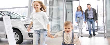 family-buying-used-car.jpg Happy family at a Vermont used car dealership picking up their new vehicle