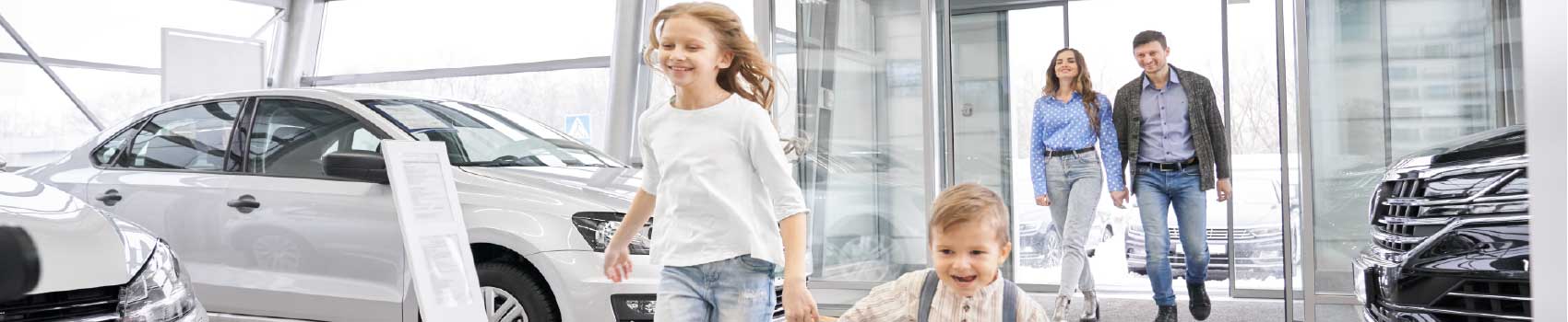 family-buying-car.jpg Happy family at a Vermont used car dealership receiving keys to their new vehicle