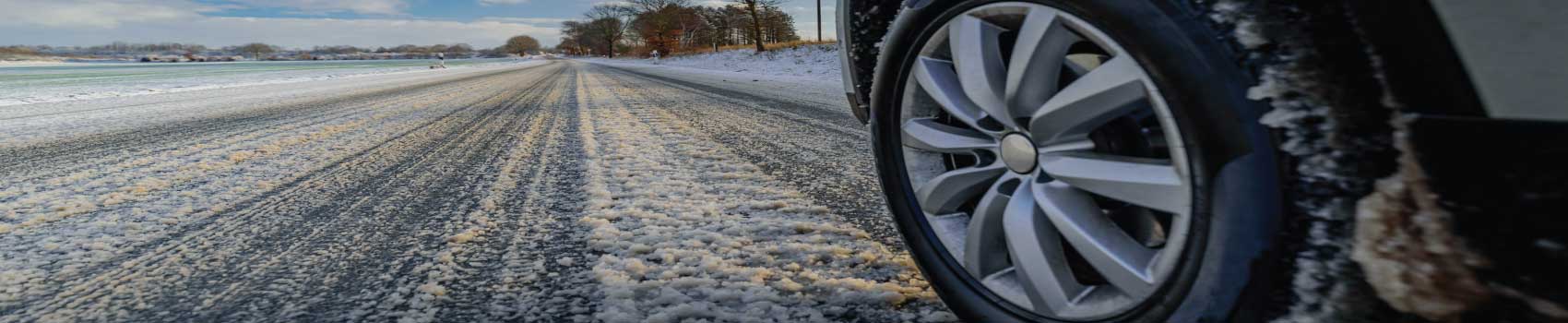 Vehicle driving on a snowy Vermont road during winter salt season