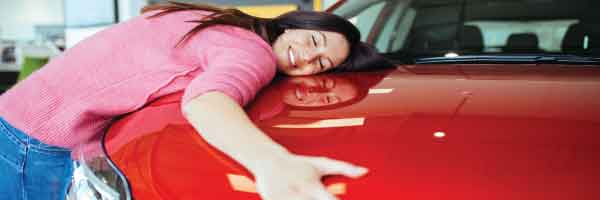  Customer hugging her new car after a no dealer fees purchase at Central Vermont Auto Mart