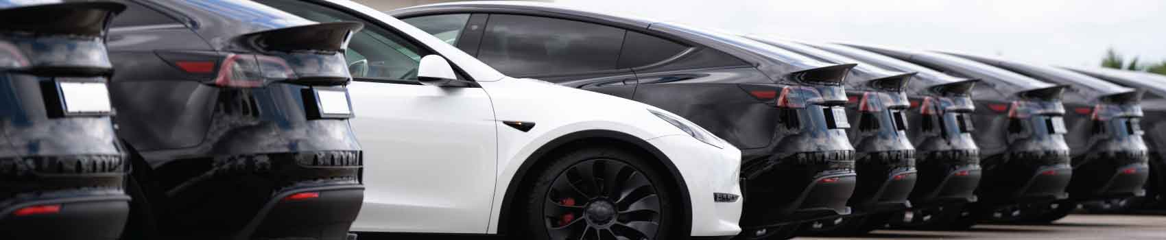 Line of late-model electric vehicles representing projected increase in used EV lease returns in 2026