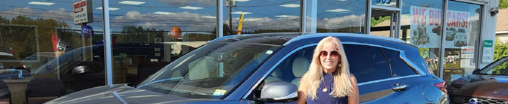Central Vermont Auto Mart showroom with happy customer purchasing a used cars for sale in Montpelier, Vermont