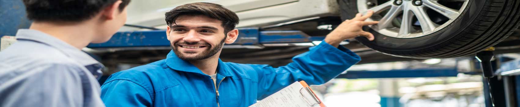 vehicle-maintenance-myths-vermont.jpg Mechanic explaining car maintenance tips to Vermont driver at auto shop in Montpelier