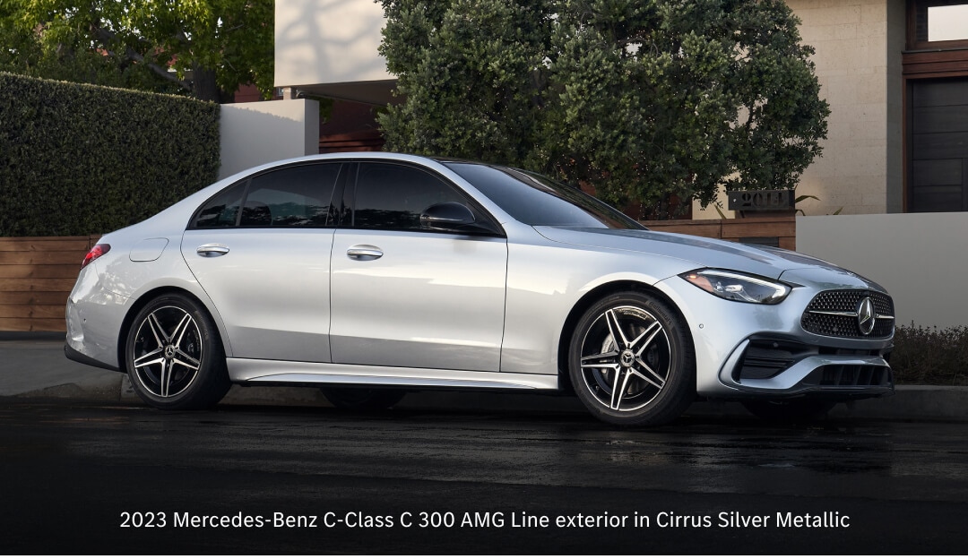 Front three-quarter view of 23 Mercedes C-Class C 300 AMG Line in Cirrus Silver stationary in a modern residential setting.