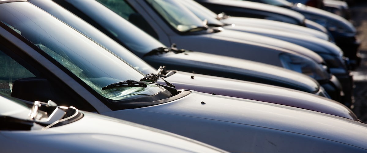Used cars parked in a row at dealership