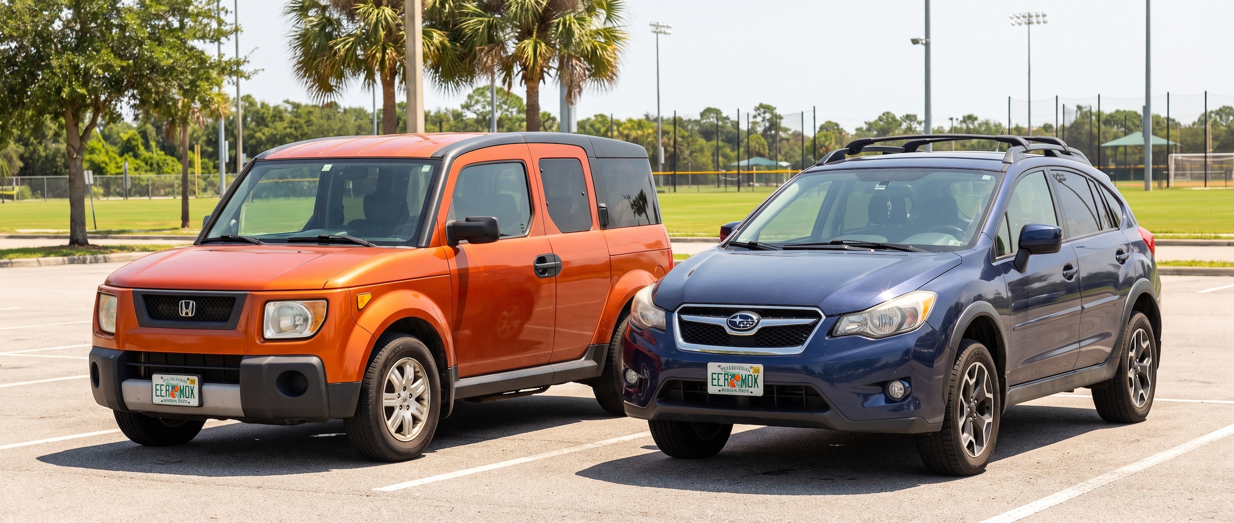 Two compact used SUVs parked side by side in a sunny Florida parking lot near a large outdoor sports complex. One is a boxy, upright hatchback in a vibrant color and one is a compact crossover with a raised SUV stance. August afternoon light, lush green grass in the background, Gulf Coast summer atmosphere