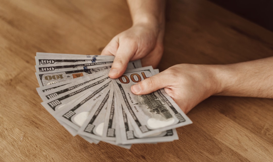 cash in hands over table top.jpg
