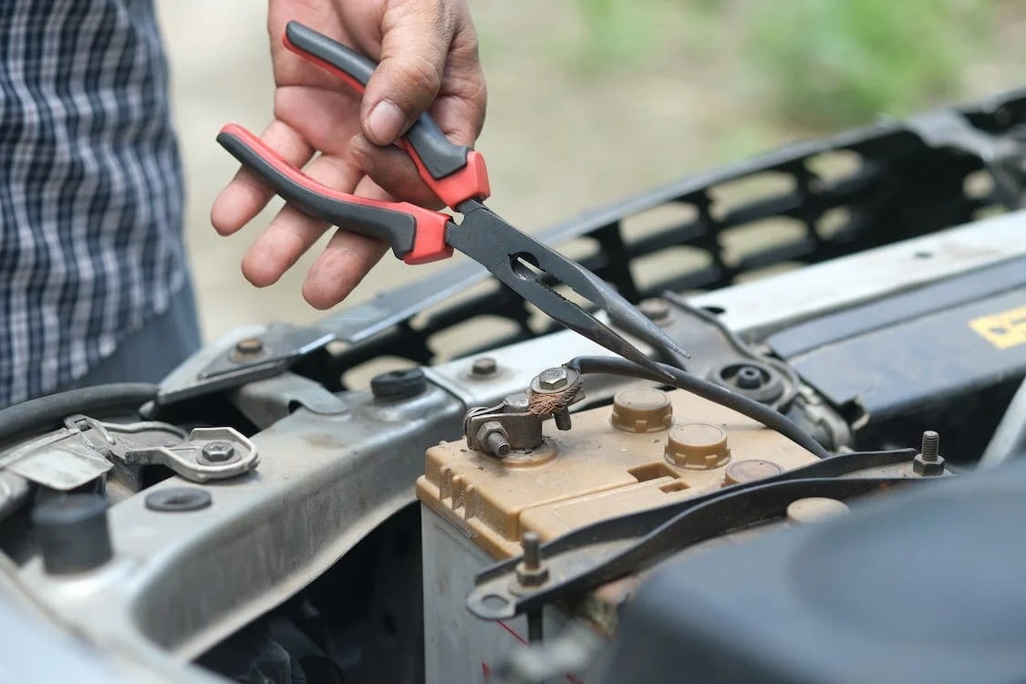  someone working on their car battery