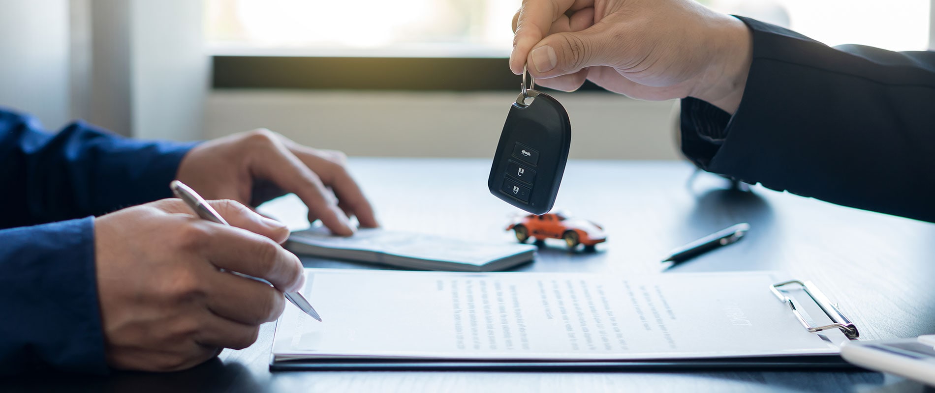 Finance Used Cars, Trucks & SUVs for Sale in Canfield, OH customer getting their keys after signing a financing agreement