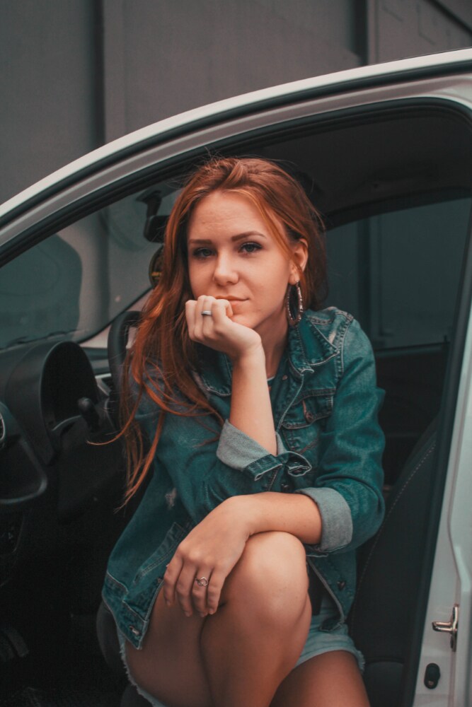 female sitting in her car looking at camera.jpg