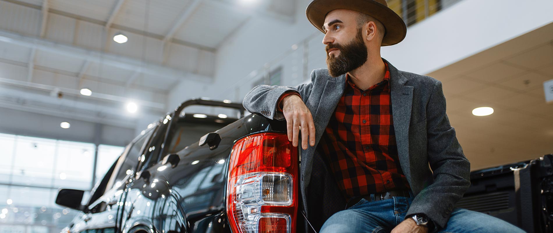Happy man sitting in the bed of his Ford truck