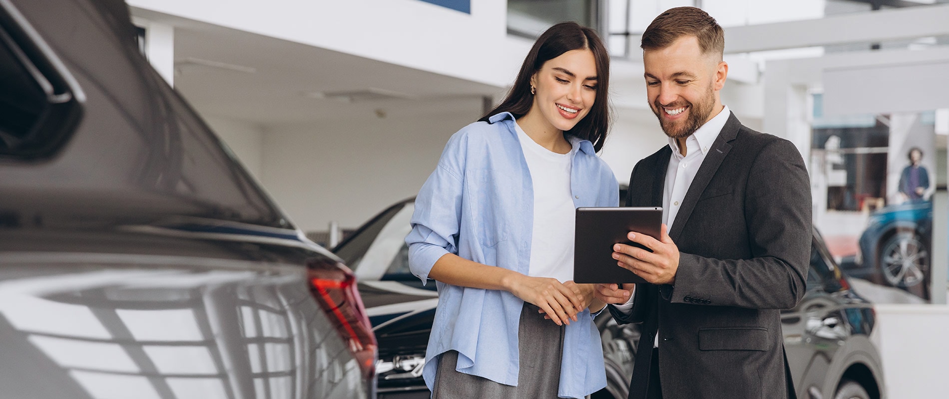 Woman discussing her vehicle options with a sales representative