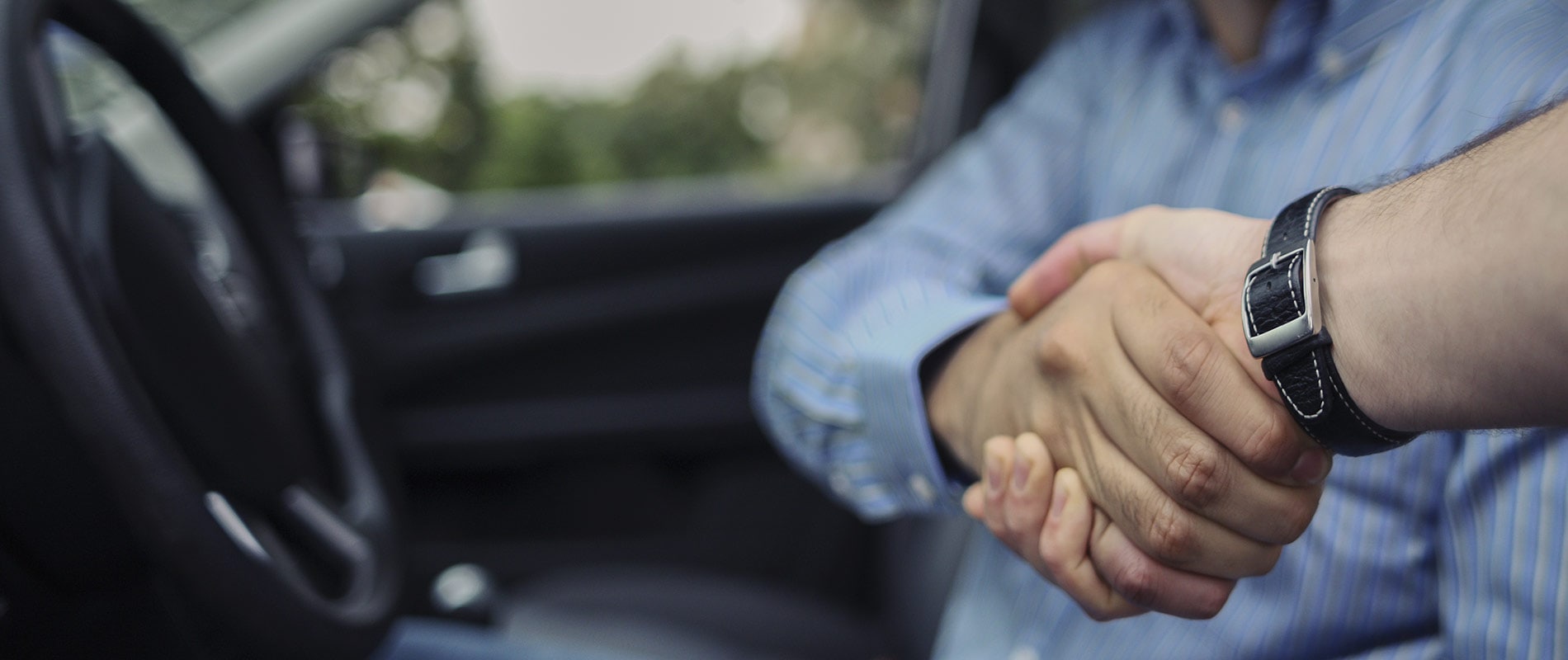 Smiling man shaking hands with a sales representative