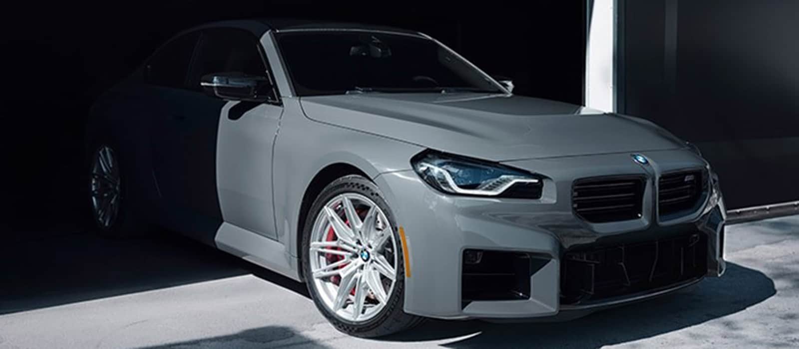 2025 BMW M2 pulling out of a garage