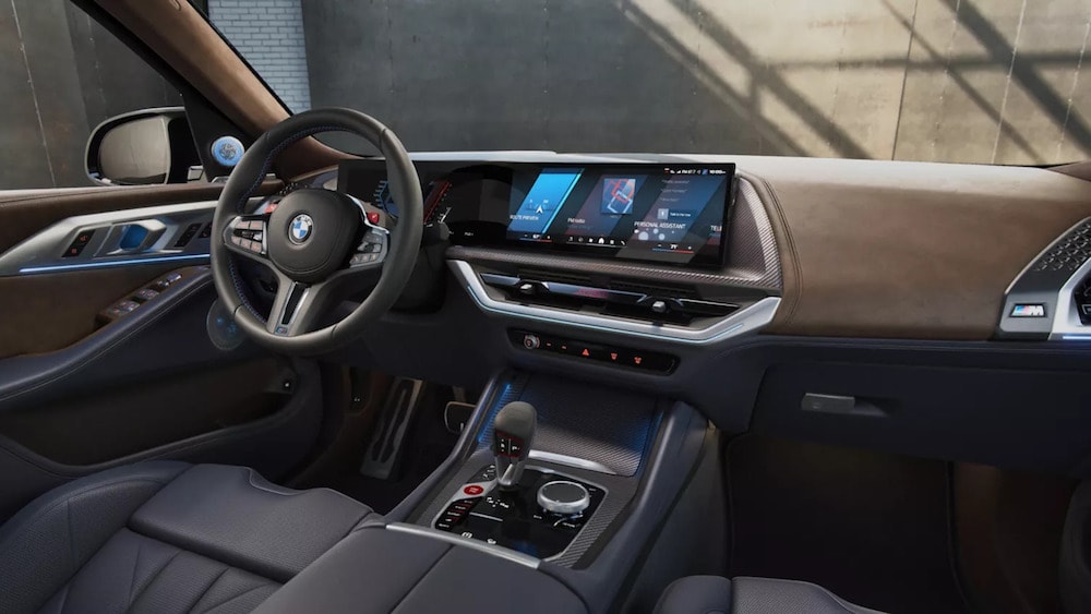The front seat, steering wheel, and dashboard of a 2026 BMW XM SUV