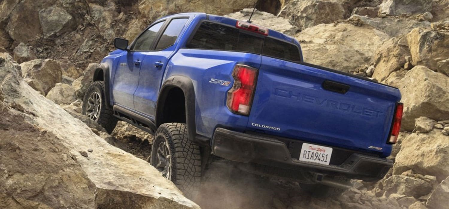 2026 Chevrolet Colorado driving up a rocky hill
