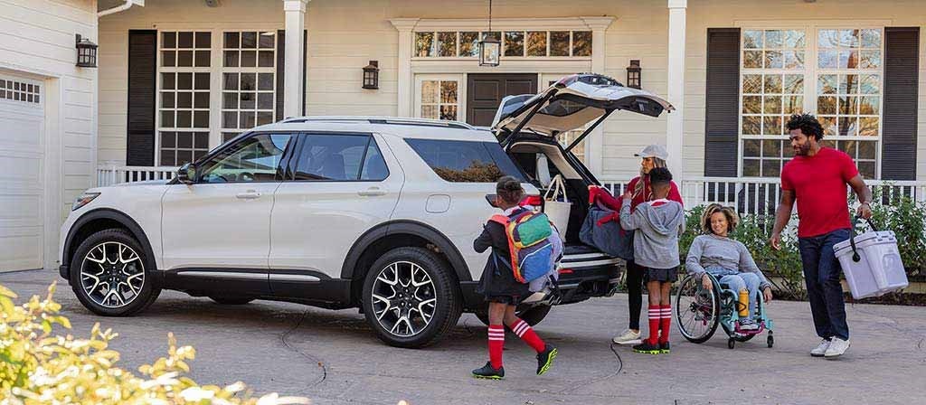 Family piling in to their new Ford Explorer