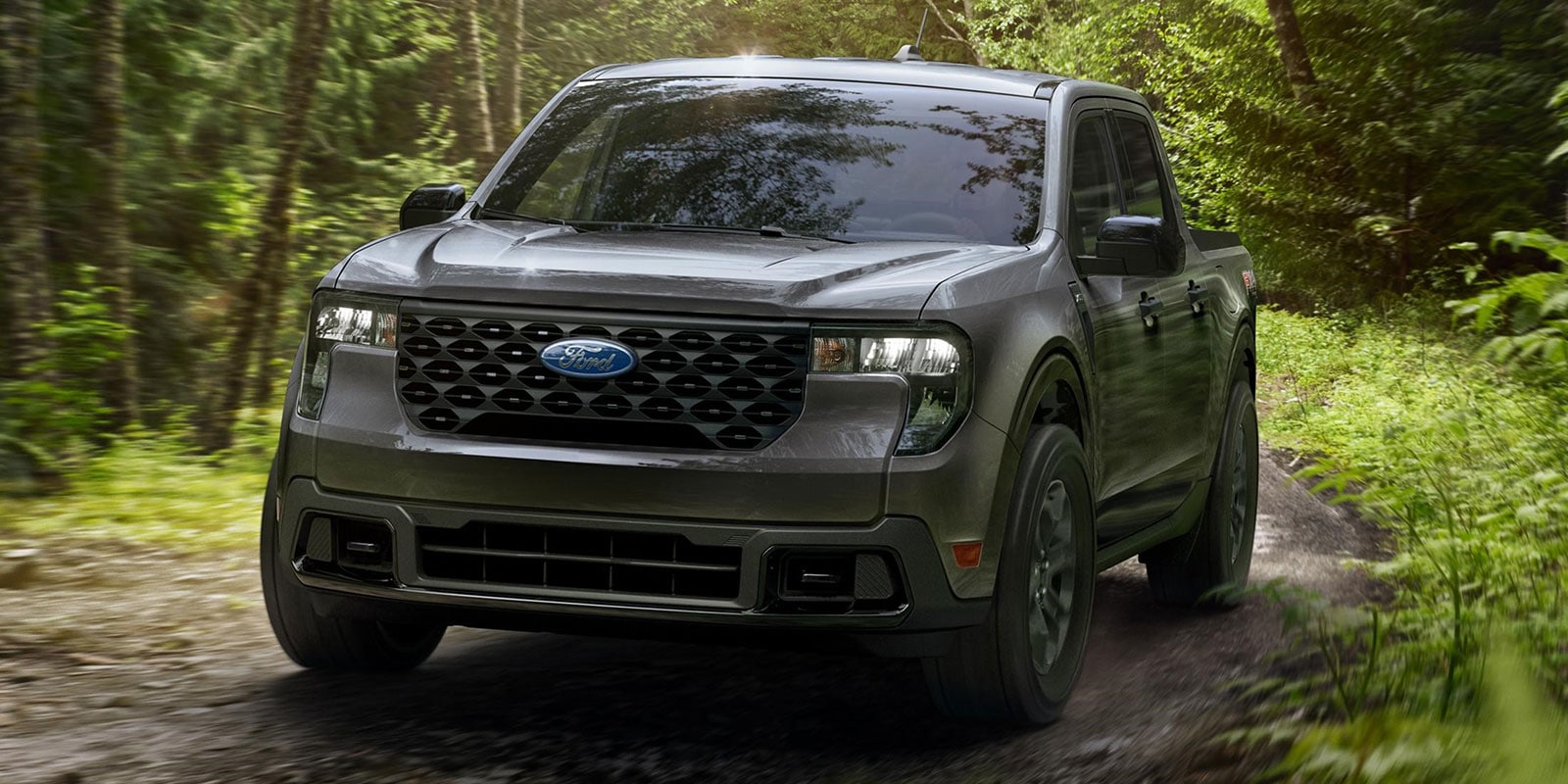 2026 Ford Maverick driving on a forest path