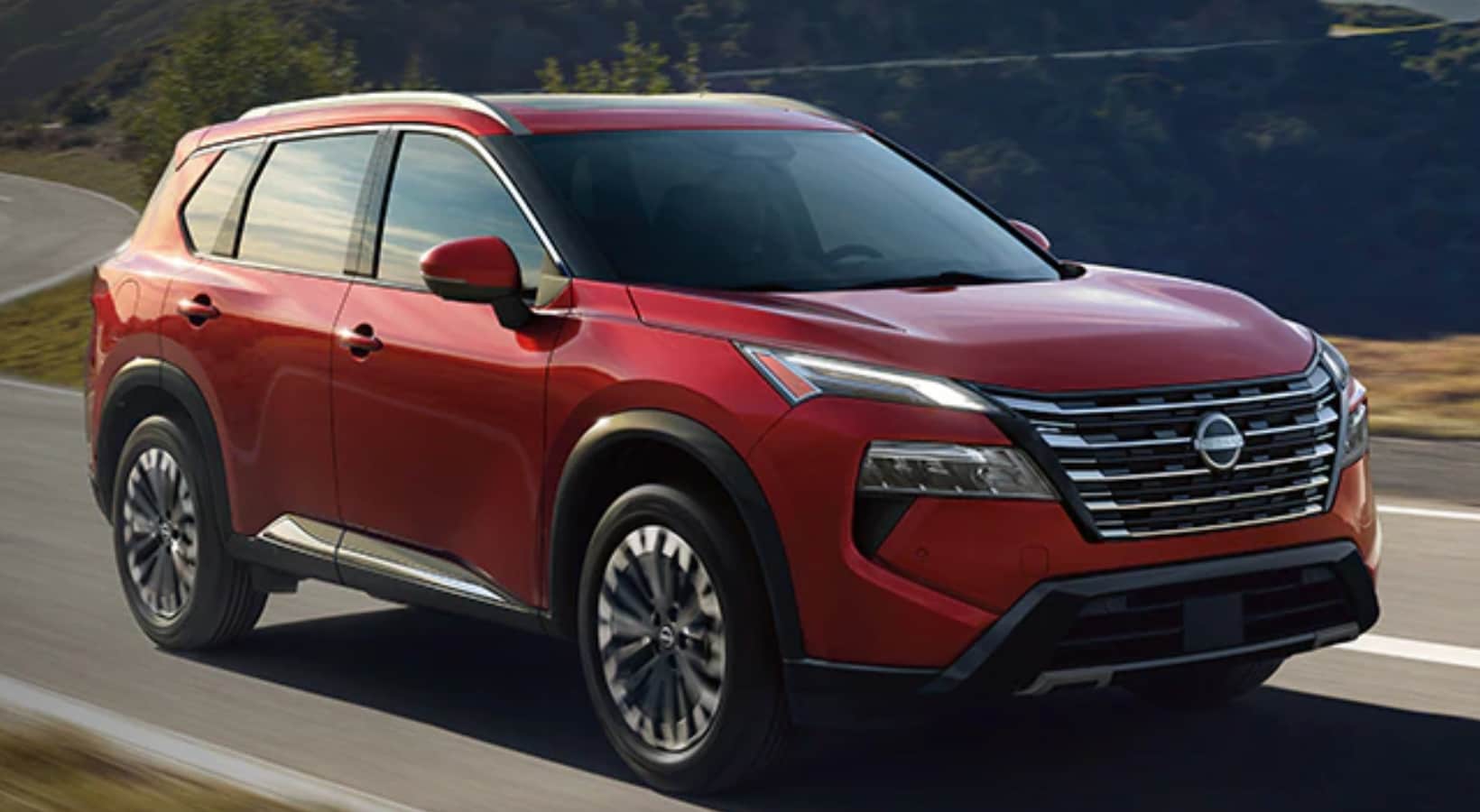 2024 Nissan Rogue driving down the road