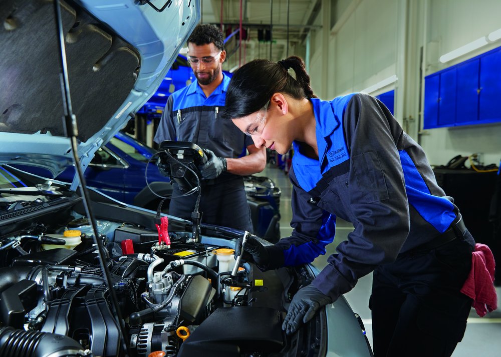 Woman installing car battery