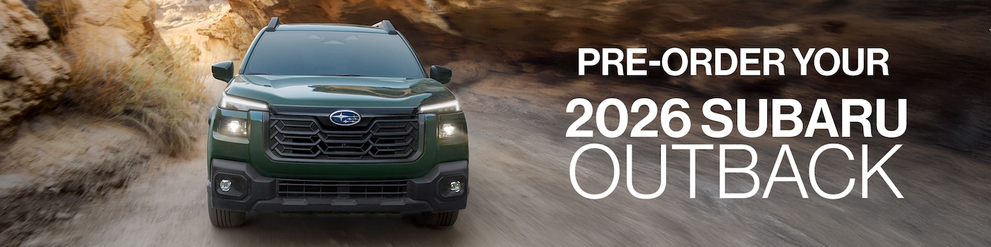  2026 Green Subaru Outback driving on dirt path