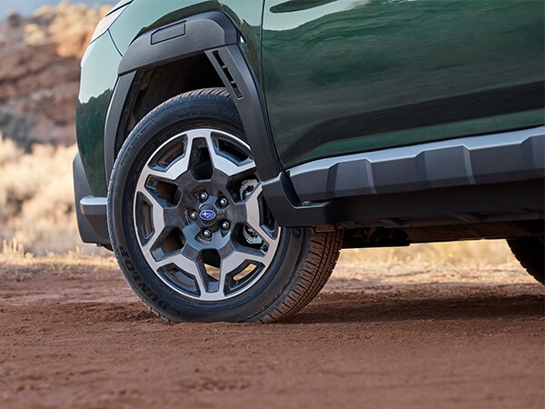  2025 Green Subaru Outback tire driving on dirt path
