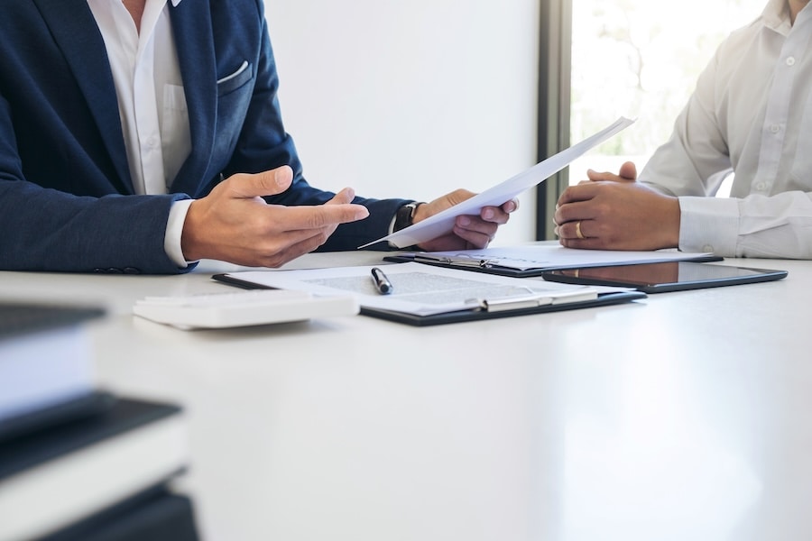 Two people reviewing paperwork at a desk