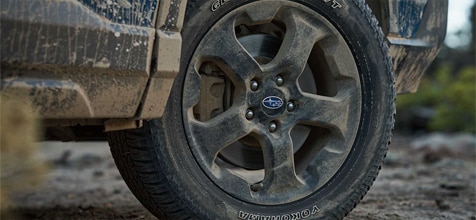 matte black finish wheels with all-terrain tires and full-size spare