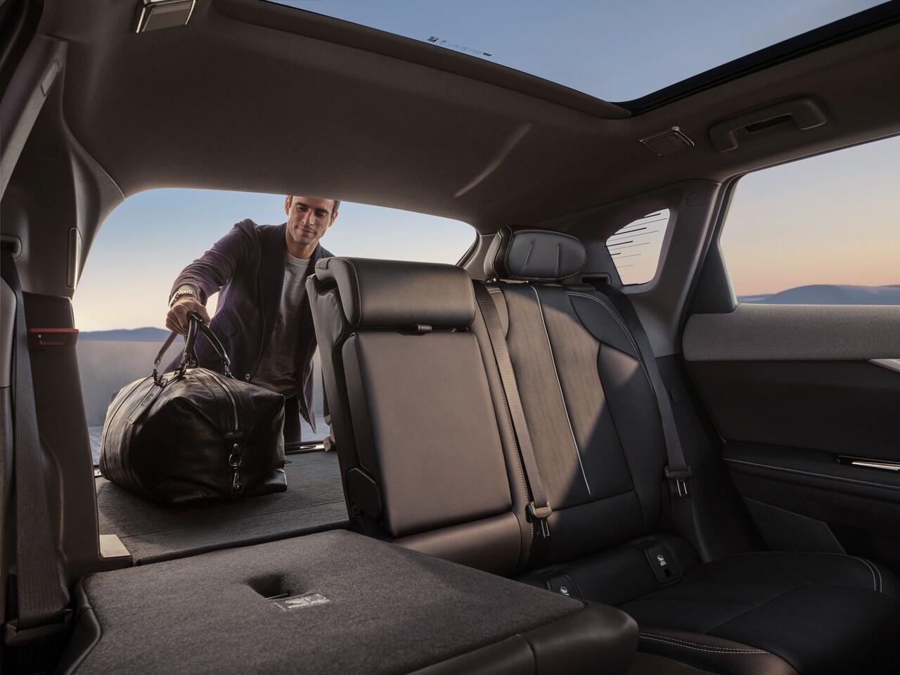  Rear/side view of silver 2025 Cadillac OPTIQ